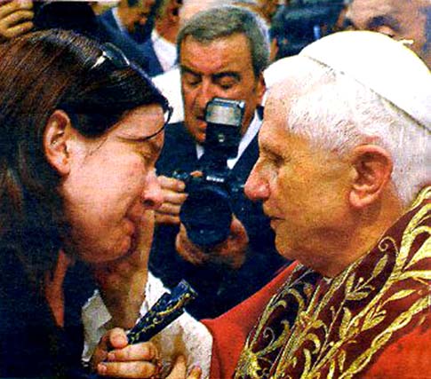Benedict XVI caressing the cheek of an emotional woman